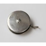 A George V silver and white metal cased tape measure by Crisford & Norris, Birmingham 1914