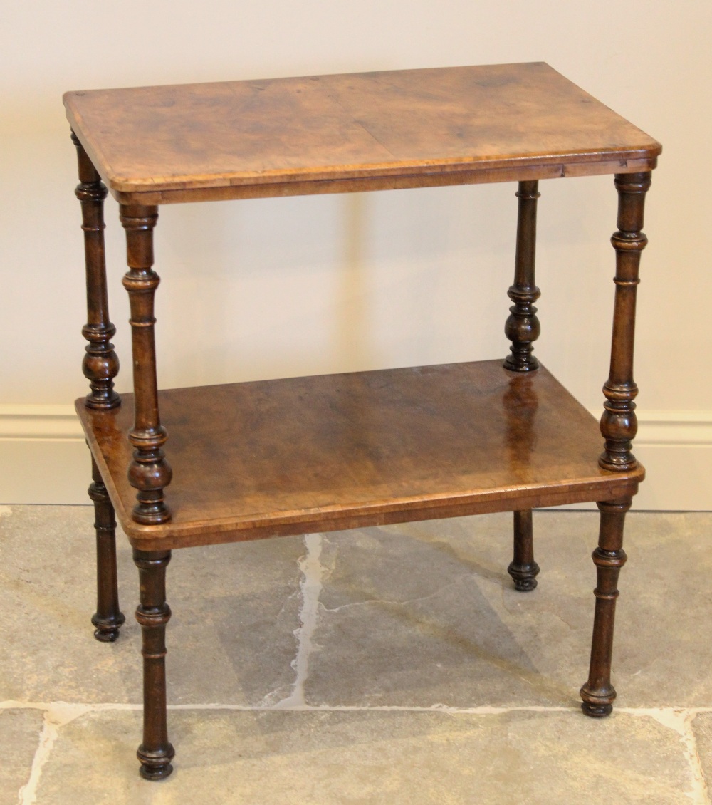 A Victorian burr walnut two tier occasional table, the rectangular tiers raised raised upon turned