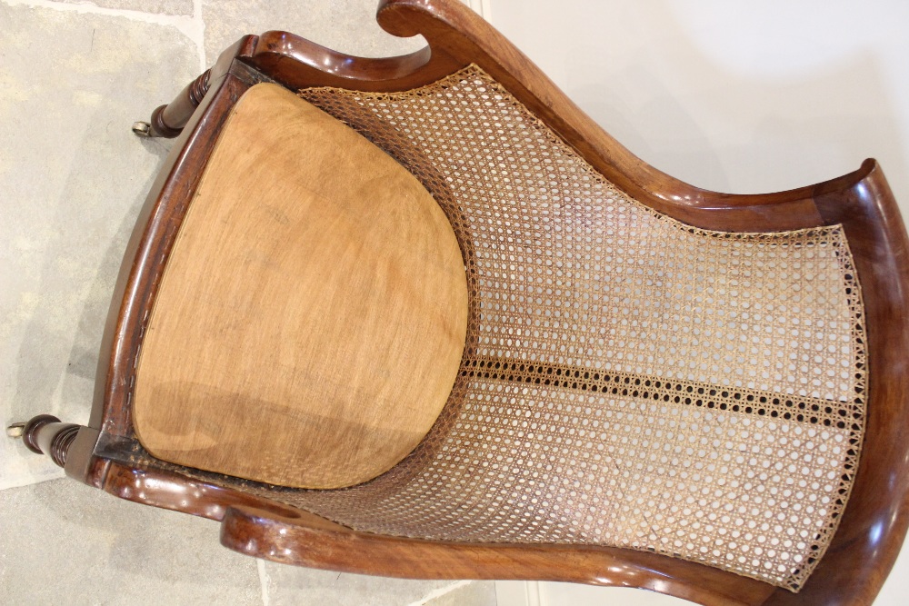 A late Regency mahogany bergère tub chair, the shaped back extending to down swept arms enclosing - Image 2 of 2