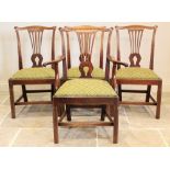 A set of seven George III mahogany Hepplewhite style dining chairs, each chair with a pierced