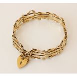 A 9ct gold gate link bracelet, hallmarks for London 1982, 19cm long, suspending a 9ct gold heart-