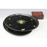 A Victorian black lacquered papier mache tray, mid 19th century, of oval form, hand painted with