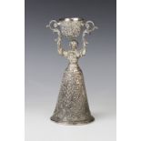 A continental silver plated wager cup, in the form of a finely dressed lady with full skirt