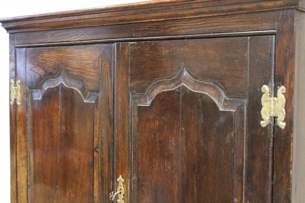 A mid 18th century and later oak cabinet on stand, the moulded cornice above two fielded panel doors - Image 3 of 4