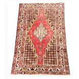 A Turkish Ziegler carpet, the central red lozenge shaped medallion, on a brown ground with