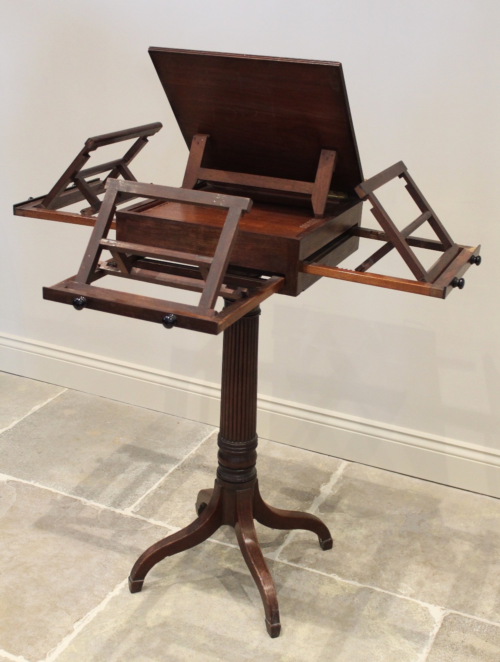 A George III mahogany pedestal quartet music stand, in the manner of Gillows, the rectangular