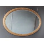 A 19th century gilt wood oval wall mirror, the bevelled mirrored plate within a reeded frame, 84cm H