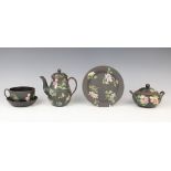 A selection of Wedgwood black basalt tea wares decorated in the 'Chinese Flowers' pattern, 19th