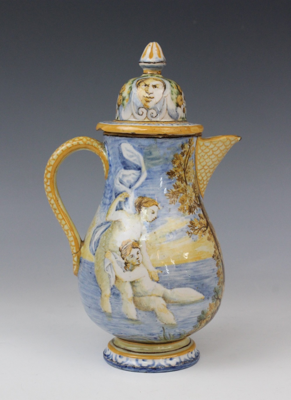 An Italian faience ewer and cover in the manner of Cantagalli, 20th century, decorated with a