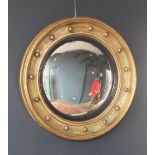 A 19th century circular convex wall mirror, the gilt wood moulded frame applied with bead detail and