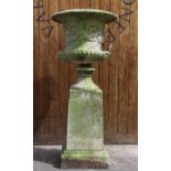 A reconstituted stone campana garden urn, of typical lobed form, moulded in relief with scrolling