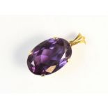 A synthetic sapphire pendant, the oval mixed cut synthetic 'colour-change' sapphire (measuring