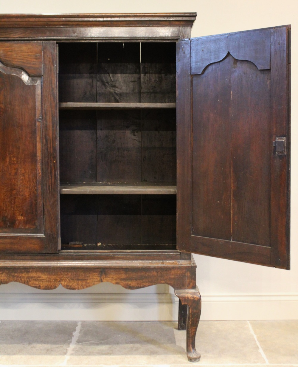 A mid 18th century and later oak cabinet on stand, the moulded cornice above two fielded panel doors - Image 4 of 4