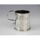 A Queen Anne silver mug, of tapered cylindrical form on raised circular foot with simple loop