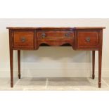 A Regency mahogany sideboard, the break bow front with central frieze drawer flanked by cupboard