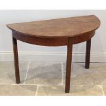 A George III honey oak D-end side table, the bow front top raised upon legs of square section,