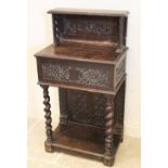 A 17th century and later carved oak hall stand, the raised back upon an early hinged bible box,