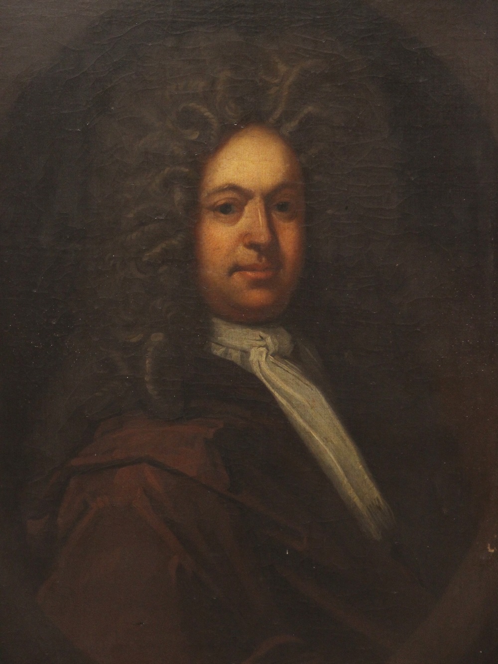 Circle of Godfrey Kneller (1646-1723), Portrait of Thomas Kenyon in a painted oval half length