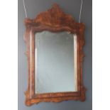 A 19th century French walnut framed wall mirror, the replaced mirrored plate within a relief moulded