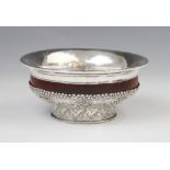 A Tibetan wood and white metal offering bowl, 15cm diameter