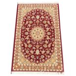 A fine woven thick pile rug, the rich red ground with lozenge Shabas medallion design, 162cm x 100cm