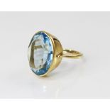 An 18ct gold paste set cocktail ring, the central oval mixed cut blue paste (measuring 20mm x 14mm),