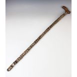 A 19th century vertebrae walking stick, with wooden handle, 90cm long