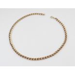 A yellow metal curb link chain, with spring ring and loop fastener, marked '9ct', 41.3cm long,