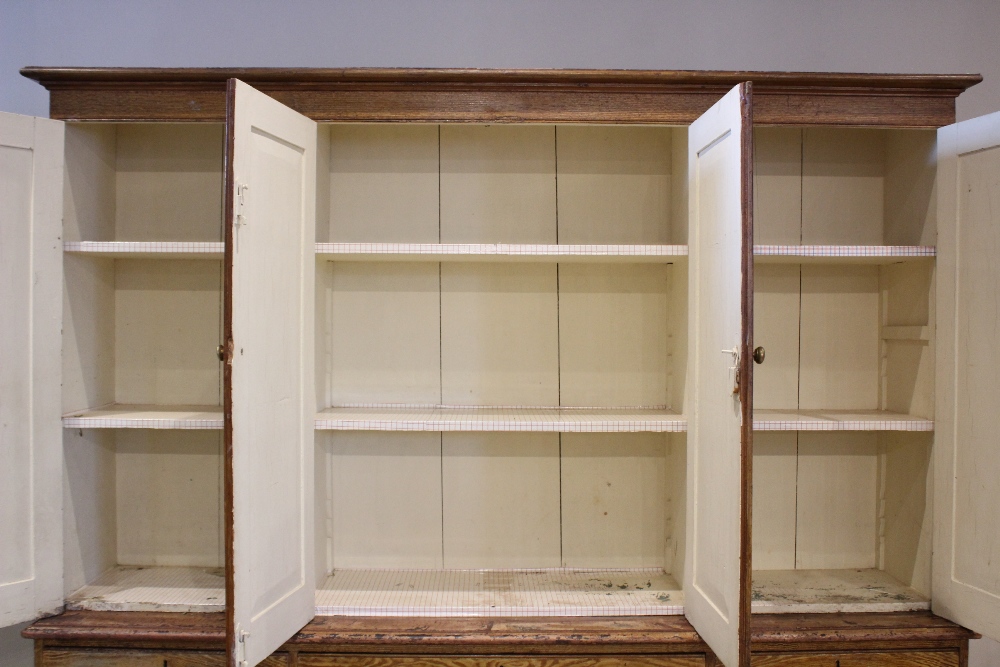 A Victorian scumbled pine housekeepers cupboard, the moulded cornice above four invert panelled - Image 3 of 7