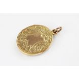 A George V 9ct gold locket pendant, of oval form, engraved with scrolling and foliate decoration,