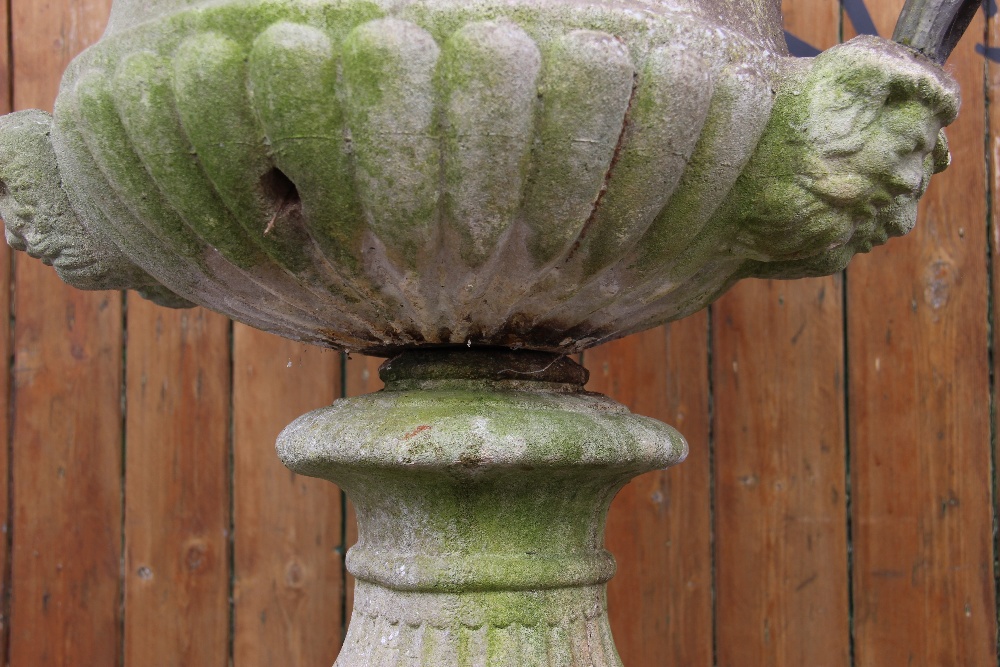 A reconstituted stone campana garden urn, of typical lobed form, moulded in relief with scrolling - Image 6 of 6
