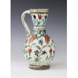 An Ottoman Empire Turkish polychrome pottery jug, of pear shape with attached handle and flared