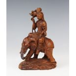 A Chinese sandalwood carving of Guanyin upon an elephant, 16.5cm high (at fault)