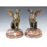 A pair of patinated bronze sphinx, early 20th century, modelled in the Art Deco style, each seated