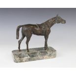 A bronze patinated sculpture of a racehorse, modelled standing saddled, set to a green marble