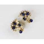 A pair of sapphire and diamond spray earrings by Gazdar, each comprising three oval mixed cut