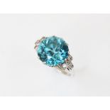 An Art Deco blue zircon and diamond ring, the central round mixed cut zircon (measuring 12mm