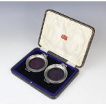 A cased pair of George V silver mounted glass dishes by Adie Brothers, Birmingham 1935, each of