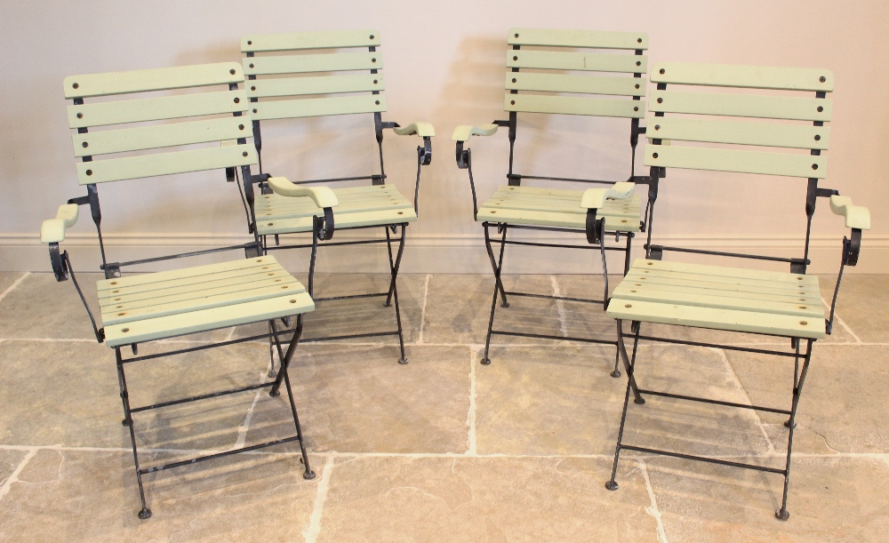 A set of four French style folding bistro chairs, mid 20th century, each chair with a painted