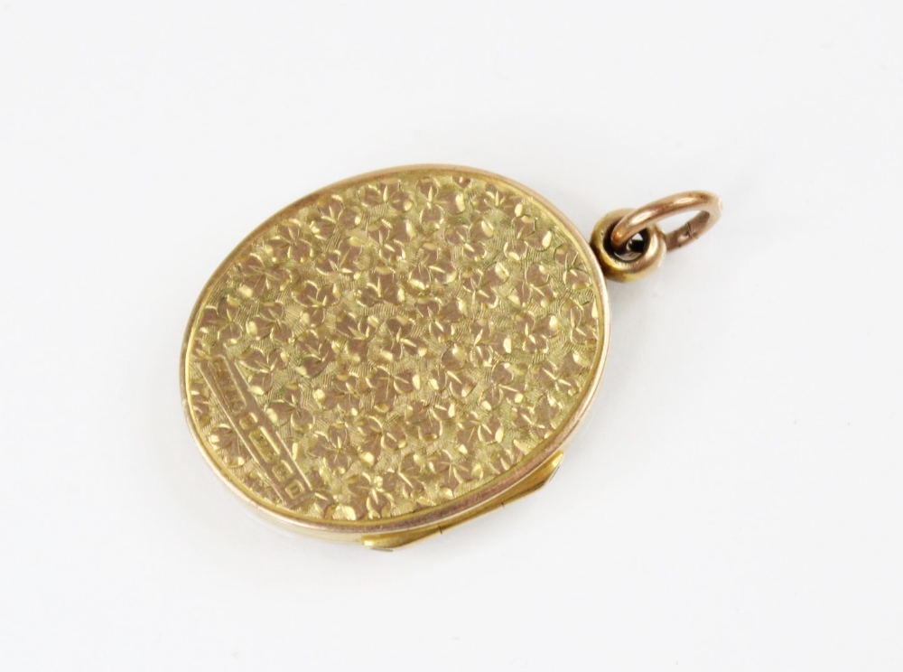 A George V 9ct gold locket pendant, of oval form, engraved with scrolling and foliate decoration, - Image 2 of 3