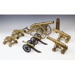 A collection of cast brass table top model cannon, 20th century, the largest raised on two wheels