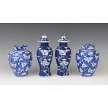 A pair of Chinese blue and white prunus pattern vases and covers, each of slender baluster form,