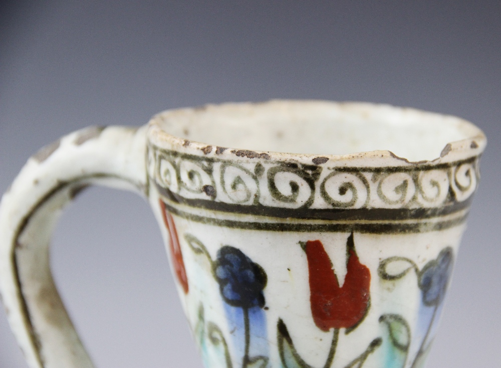 An Ottoman Empire Turkish polychrome pottery jug, of pear shape with attached handle and flared - Image 5 of 9
