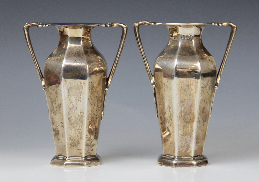 A pair of Edwardian silver twin-handled vases by Goldsmiths & Silversmiths Company, London 1909,