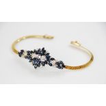 A sapphire and diamond bracelet, designed as an abstract cluster set with thirty-four marquise