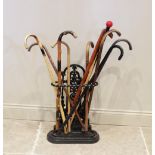 A Victorian style cast iron stick stand, the open work upright extending to a rope twist rail