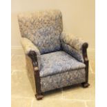 A 19th century upholstered mahogany armchair, in the manner of Howard Woodstock, in blue foliate