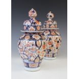 A pair of Japanese Imari vases, Meiji period (1868-1912), each of small temple proportions with
