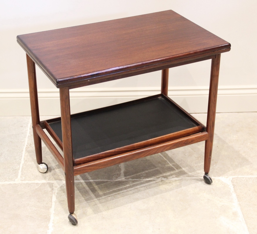 A mid century rosewood drinks trolley, probably Indian, the folding and revolving top tier above a