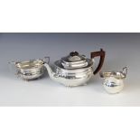 A George V three-piece silver tea service by Adie Brothers Ltd, Birmingham 1934-6, comprising